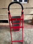  Red, foldable, 5-step hand-grip ladder, likely made of aluminum. 